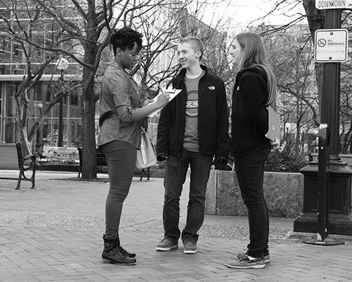 Sophomore Lindsey Rayner and freshman Jamie Porter receive information from a University of Iowa student at the Iowa City pedestrian mall on Monday, March 21, 2016. Lindsey and Jamie were gathering names and information for the upcoming Presidents Block Party. (The Daily Iowan/Tawny Schmit)