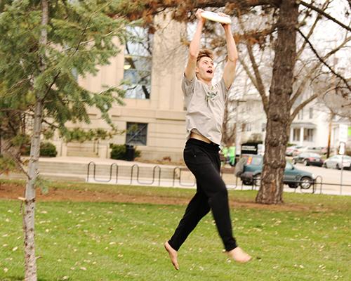 Freshman Gavin Thayer catches a frisbee near the Pentacrest on Wednesday, March 30. Gavin and his friends were playing an afternoon game of ultimate frisbee. (The Daily Iowan/Tawny Schmit) 
