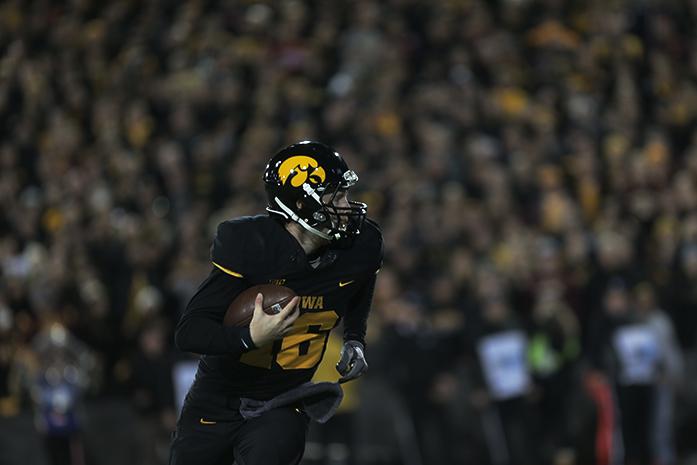 Iowa+quarterback+C.J.+Beathard+runs+with+the+ball+during+the+Iowa-Minnesota+game+at+Kinnick+on+Saturday%2C+Nov.+14%2C+2013.+The+Hawkeyes+defeated+the+Golden+Gophers%2C+40-35+to+stay+perfect+on+the+season.+%28The+Daily+Iowan%2FMargaret+Kispert%29
