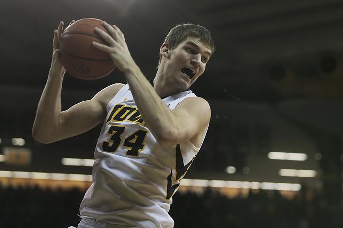 Iowa center Adam Woodbury grabs a rebound against Indiana on Tuesday, March 1, 2016 in Carver-Hawkeye in Iowa City, IA. The Hoosiers defeated the Hawkeyes, 81-78. (The Daily Iowan/Joshua Housing)