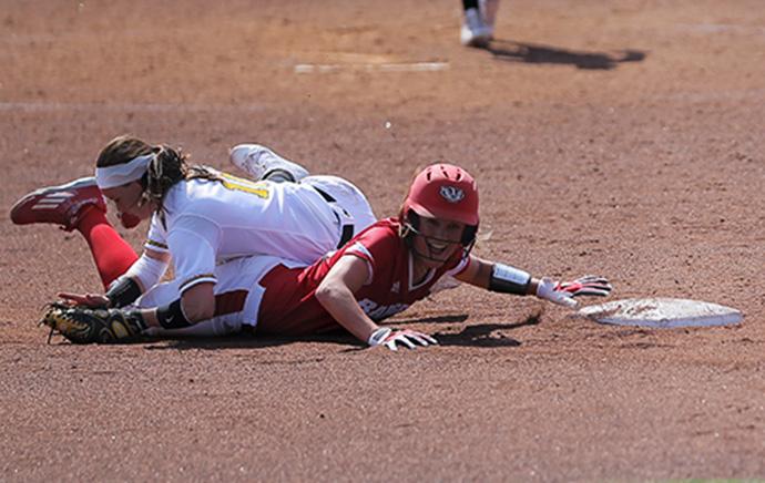 Iowa shortstop Katy Taylor misses the throw down to second and allows Wisconsin’s Ashley Van Zeeland to slide safely into second. The Badgers defeated the Hawkeyes, 3-1 taking the three game series. (The Daily Iowan/Margaret Kispert)