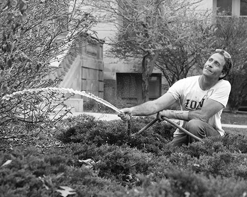 Bob Hester waters the plants in front the Pentacrest on Monday, April 18, 2016. Hester works for the University of Iowa landscape services. (The Daily Iowan/Schmit)