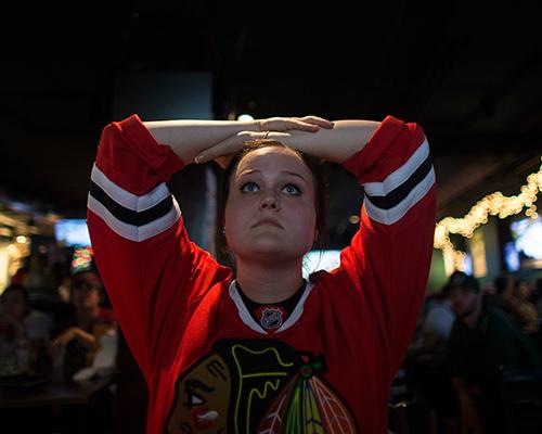 UI senior Ali Morrison reacts to Chicago Blackhawks losing in the first round of the NHL playoffs at the Vine on Monday. The Blackhawks, last year’s champions, got the blues from St. Louis in Game 7, 3-2. (The Daily Iowan/Margaret Kispert)