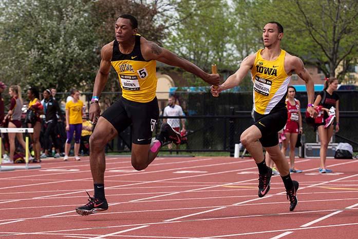Iowa+runner+James+Harrington+hands+off+the+baton+to+teammate+Keith+Brown+in+the+4x100+meter+relay+during+the+Musco+Twilight+at+the+Cretzmeyer+Track+on+Saturday%2C+May+2%2C+2015.+The+Iowa+relay+team+won+the+event+with+a+time+of+39.66.+The+Iowa+Track+and+Field+team+won+seven+events+during+the+meet.+%28The+Daily+Iowan%2FJohn+Theulen%29