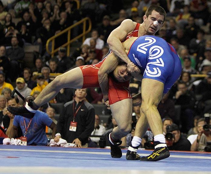 Iowa City, Iowa- Brent Metcalf (red) wrestles Jared Frayer (blue) in the finals of the Team USA 2012 Olympic Wrestling Trials at Carver-Hawkeye Arena on Sunday, April 22, 2012. Frayer defeated Metcalf in 2 rounds to earn a place on the 2012 U.S. Olympic team. (The Daily Iowan/Adam Wesley)
