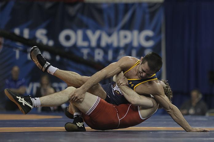 Iowas Daniel Dennis grabs fellow Iowa alum Tony Ramos during their 57kg Championship match at the U.S Olympic Wrestling Team trials at Carver-Hawkeye Arena on Sunday, April 10, 2016. Dennis will be competing for the gold this summer in Rio. (The Daily Iowan/Valerie Burke)