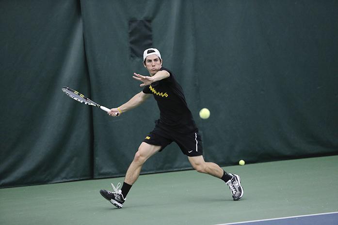 Iowas Dominic Patrick attempts to hit the ball during the Iowa-Minnesota meet in the Hawkeye Tennis and Recreation Complex on Sunday, March 28, 2016. The Hawkeyes defeated the Golden Gophers, 4-1. (The Daily Iowan/ Margaret Kispert)