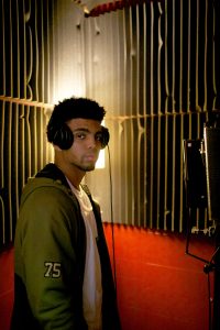 Omar Truitt records in his studio, downtown Iowa City on Tuesday, May 10, 2016. Truitt is a former Hawkeye football player. (The Daily Iowan/Mary Mathis)