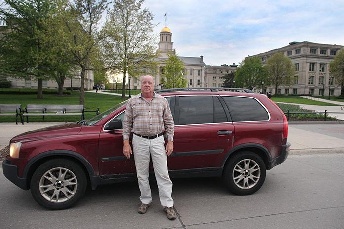 Uber driver Donald Ebner poses on Clinton Street in Iowa City, IA on May 2, 2016. Uber was approved for Iowa City this past week, but Ebner has been a driver for 10 months. Ebner, a retired police officer, started driving because he likes to meet new people. (Photo Illustration by Joshua Housing)