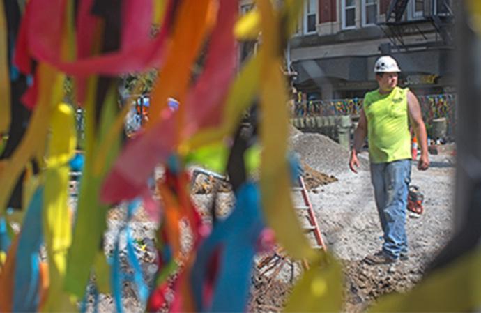 Construction workers work on tearing down the old pavement for the new road on Washington St. Monday, June 13. Construction is supposed to span through July, and even into the fall 2016 semester. (The Daily Iowan/Jordan Gale)