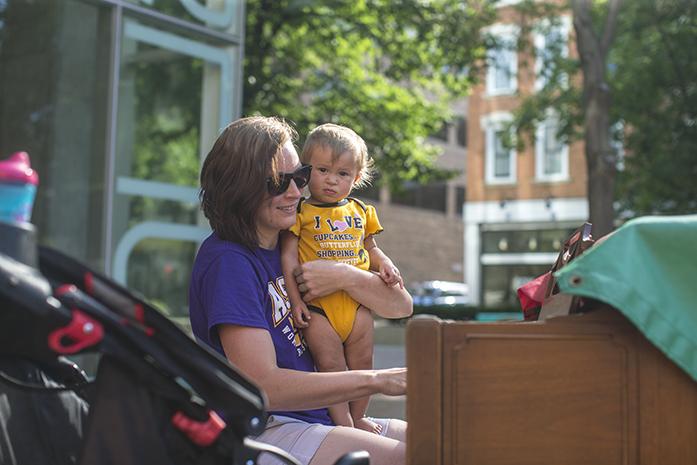 Kayla Crist (left) and Layla Crist, 1, play piano together on the Black Hawk Mini Park on Monday afternoon, June 27, 2016.  (The Daily Iowan/Joseph Cress)