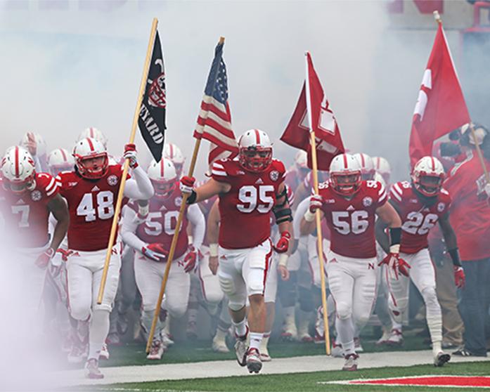 The Nebraska team runs out before the Iowa-Nebraska game at Memorial Stadium on Friday, Nov. 27, 2015. The attendance for the game was 90,830 people. The Hawkeyes defeated the Cornhuskers, 28-20, to finish off a perfect regular season. (The Daily Iowan/ John Theulen)