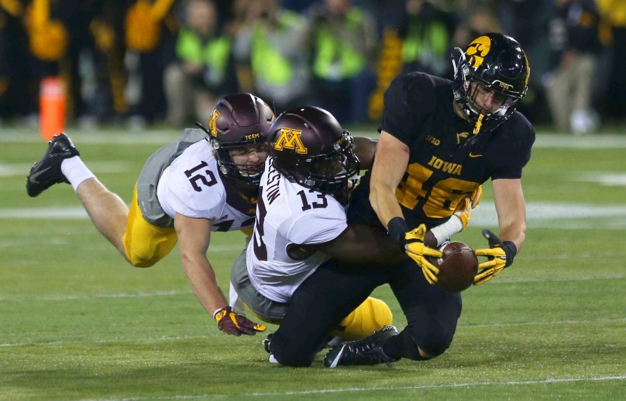 Iowa+tight+end+George+Kittle+is+tackled+by+Minnesota+linebackers+Jonathan+Celestin+and+Cody+Poock+in+Kinnick+Stadium+on+Saturday%2C+Nov.+14%2C+2015.+The+Hawkeyes+defeated+the+Golden+Gophers%2C+40-35+to+stay+perfect+on+the+season.+%28The+Daily+Iowan%2FRachael+Westergard%29