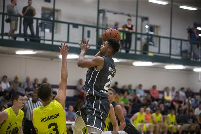 L.L. Pelling /  Comfort Care Medicare's Miles Wentzien (21) shoots in traffic during the Prime Time League season opener against Westport Touches Autowash / Linn County Anesthesiologists in Jones gym at the North Liberty Community Center on Thursday, June 30, 2016. (The Daily Iowan/Joseph Cress)