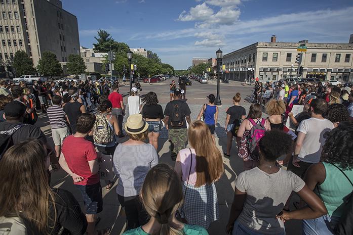 Crowds of people gather at the Pentacrest with signs to protest against police brutality on Thursday, July 14, 2016. Poetry, victim names/bios, calls of action and even talk of marching on City Hall were all brought up by multiple speakers at today's protest. (The Daily Iowan/Jordan Gale)