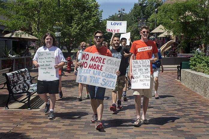 Ben Creighton, left, walks with NextGen Climate field organizer Judd Hayes and UI senior Dale Klingbeil down the Ped Mall towards South Linn Street.  Three dozen protesters joined together to speak out against Republican nominee Donald Trump on Thursday, July 21, 2016 in downtown Iowa City. (The Daily Iowan/Joseph Cress)