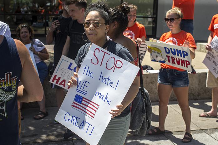 UI senior Veniesa Dillon holds a sign protesting Republican nominee Donald Trump during NextGen Climate's rally in downtown Iowa City on the Ped Mall on Thursday, July 21, 2016. (The Daily Iowan/Joseph Cress)