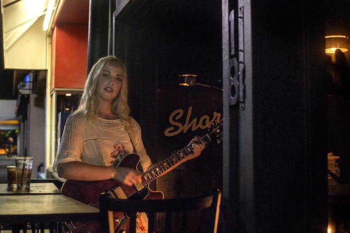 Elizabeth Moen plays guitar while performing inside Shorts Burger & Shine on Clinton Street on Sunday, July 31, 2016. Moen frequently plays an indie folkrock soul set at Shorts on Sunday nights. (The Daily Iowan/Joseph Cress)