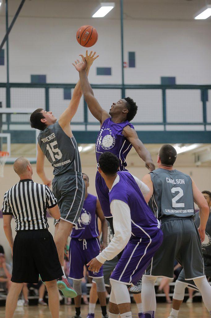 Dordt College's Ross Cooper tips offs against Iowa's Tyler Cook during the last Prime Time game of the summer in Roberts gym in North Liberty on Thursday, July 28, 2016. The L.L. Selling and Comfort Care Medicare team defeated the Beat the Bookstore and Culver's team, 80-78. (The Daily Iowan/Margaret Kispert)