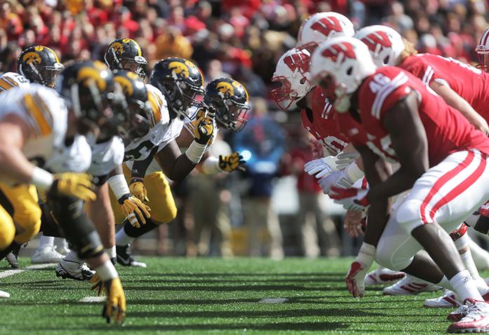 The Iowa offensive line and the Wisconsin defensive line go at eachother during the Iowa-Wisconsin game in Camp Randal Stadium on Saturday, Oct. 3, 2014. The Hawkeyes defeated the Badgers, 10-6. (The Daily Iowan/Margaret Kispert)