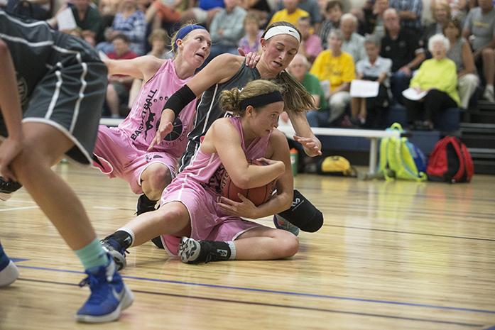 Linn County Anesthesiologists's Brenda Hafner fights to keep possession over a jump ball against L.L. Pelling's Bre Cera during a Game Time League basketball game at the North Liberty Community Center on Wednesday, July 6, 2016. (The Daily Iowan/Joseph Cress)