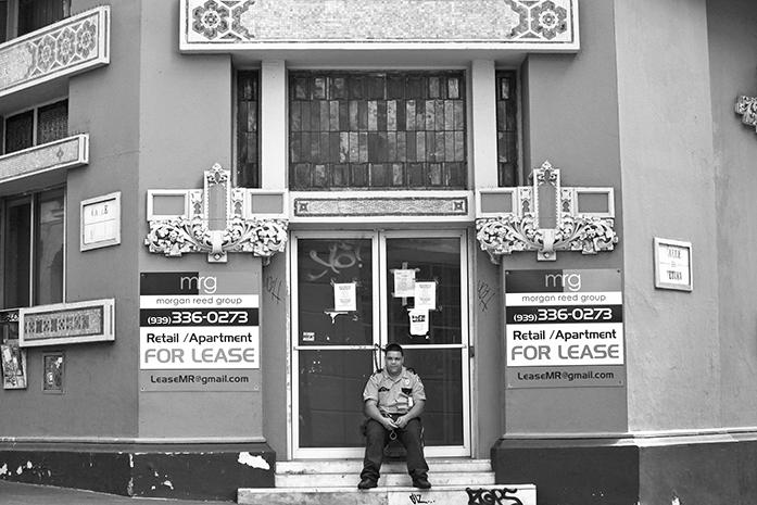 FILE - In this Aug. 2, 2015 file photo, a private security guard sits in front of a closed down business in the colonial district of Old San Juan, Puerto Rico. Congress edged closer to delivering relief to debt-stricken Puerto Rico as the Senate on Wednesday, June 29, 2016, cleared the way for passage of a last-minute financial rescue package for the territory of 3.5 million Americans. (AP Photo/Ricardo Arduengo, File)