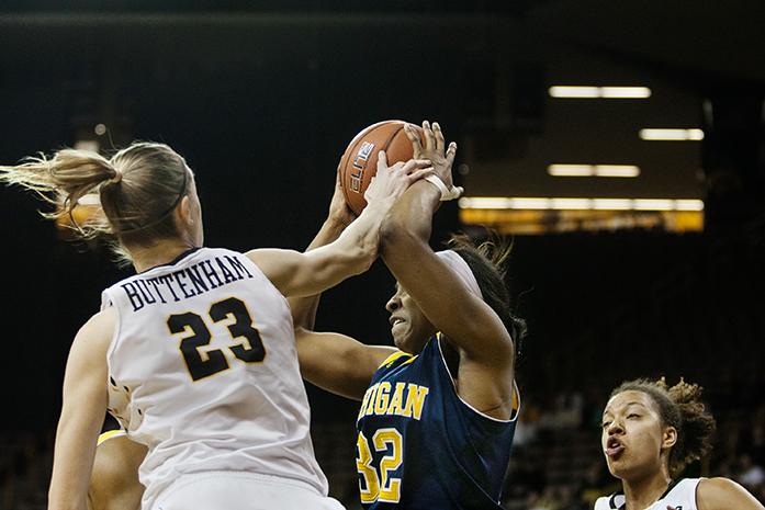 Iowa forward Christina Buttenham swats at the ball in the hands of Michigan forward Kelsey Mitchell,  the Iowa Hawkeyes snatched a win against the Michigan Wolverines 85-69 at Carver-Hawkeye Arena in Iowa City, Iowa on Jan. 28, 2016(The Daily Iowan/Anthony Vazquez)