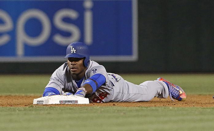 Los Angeles Dodgers Yasiel Puig reaches out for second base after being tagged out trying to stretch a single into a double against the Arizona Diamondbacks during the fourth inning of a baseball game Friday, July 15, 2016, in Phoenix. (AP Photo/Ross D. Franklin)