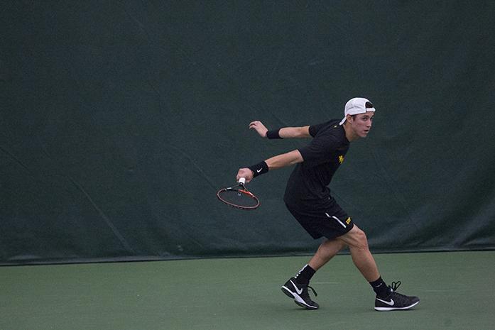 Iowas Lefteris Theodorou returns the ball during a tennis match at the Hawkeye Tennis and Recreation Complex, Friday, April 8, 2016. Illinois won over Iowa, 4-0. (The Daily Iowan/Ting Xuan Tan)