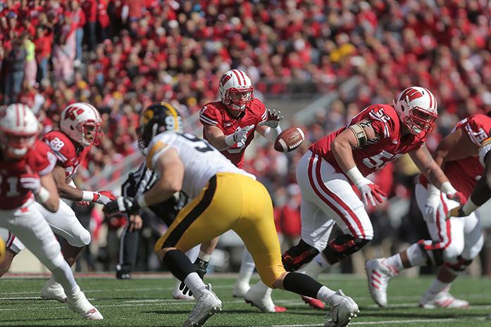 Wisconsin quarterback Joel Stave gets the ball hiked to him during the Iowa-Wisconsin game in Camp Randal Stadium on Saturday, Oct. 3, 2014. The Hawkeyes defeated the Badgers, 10-6. (The Daily Iowan/Margaret Kispert)