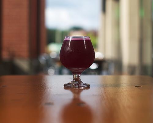 A glass of beet-orange-lyme Kombucha is shown on Brew Lab's patio on Tuesday, Aug. 30, 2016.  Wild Culture Kombucha, owned by Rachelle Schmidt and Tim Roed, is a fairly new business with multiple locations including 30 Hop, Pullman and Trumpet Blossom. (The Daily Iowan/Brooklynn Kascel)