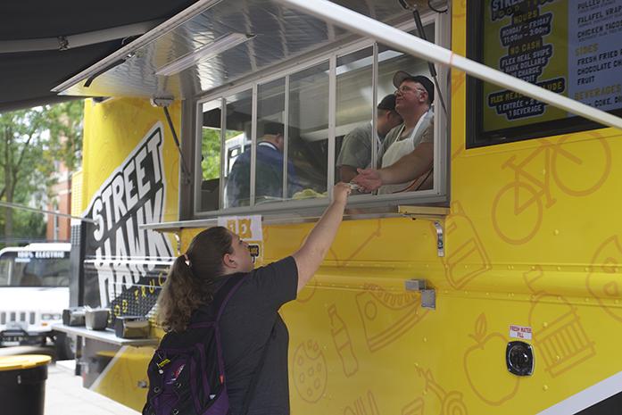 University of Iowa senior Sarah McCreary orders lunch from the Street Hawk food truck on the T. Anne Cleary Walkway at the University of Iowa. The food truck accepts flex meal swipes. (The Daily Iowan/Karley Finkel)