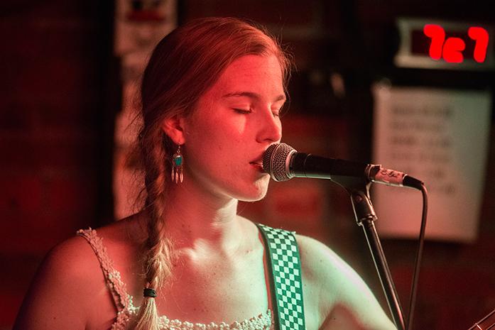 Katie Rosenberger, the bass player of The Passes, sings during an open mic night, at the Yacht Club in Iowa City on Tuesday, Sept. 20, 2016. The Passes is an indie rock pearl band from Iowa City. (The Daily Iowan/Ting Xuan Tan)