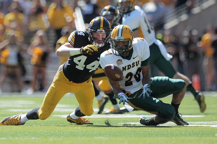 NDSU wide receiver Darrius Shepherd attempts to complete a pass as Iowa linebacker Ben Niemann is there defending during the Iowa-NDSU game at Kinnick on Saturday, Sept. 17, 2016. NDSU defeated Iowa in the final seconds of the game with a 37-yard field goal, 23-21. (The Daily Iowan/Margaret Kispert)