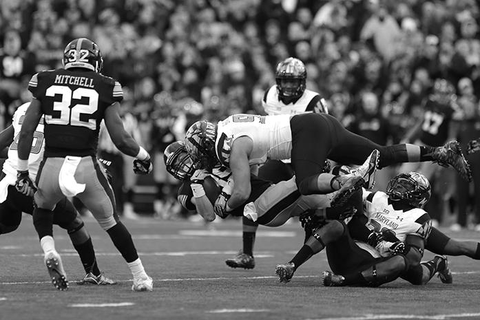 Iowa wide receiver Matt VanderBerg gets tackled by a Maryland defensive lineman during the Iowa-Maryland game at Kinnick Stadium on Saturday, Oct. 31, 2015. The Hawkeyes defeated the Terrapins to stay undefeated, 31-15. (The Daily Iowan/Margaret Kispert)