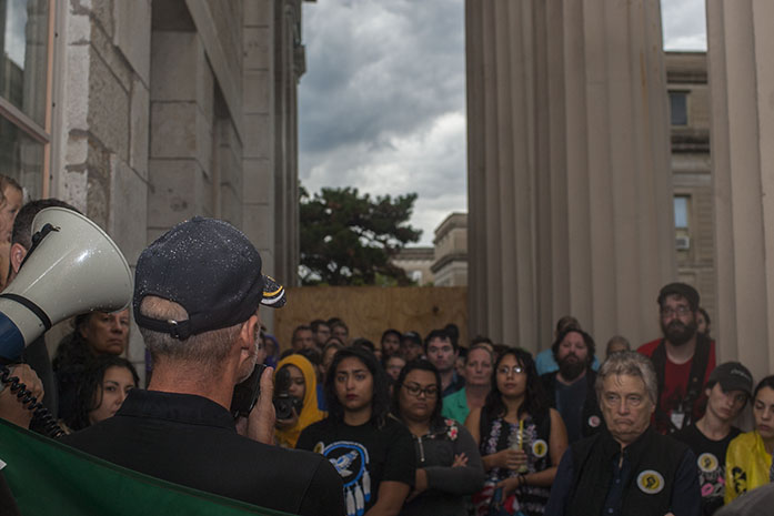 UI Lecturer Joseph Sulentic talks to a crowd of protesters about the Dakota pipeline on the Pentacrest on Thursday. The protest got cut short because of rain and lightening, and they were unable to march. (The Daily Iowan/Margaret Kispert)