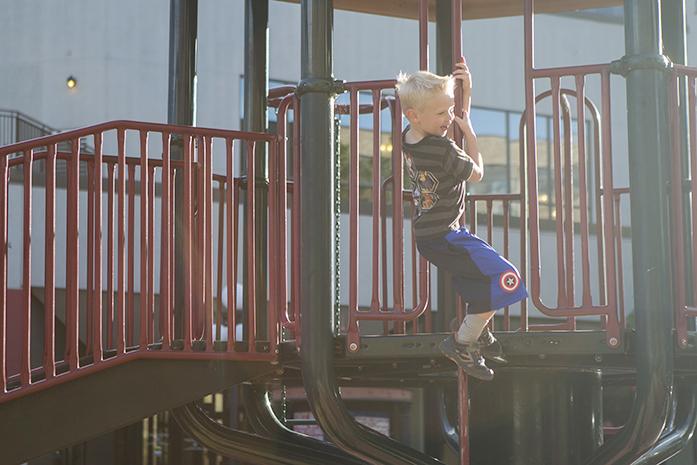 A child plays at the Ped Mall playground on Wednesday, Sep. 28, 2016. From efforts by the Iowa City Community School District's pest control committee, play and school grounds in Iowa City are moving towards eliminating nearby pesticide use. (The Daily Iowan/Olivia Sun)