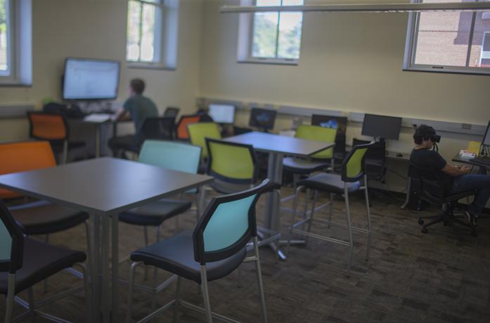 Students work in the Creative Space area in the Seamans Center library on Wednesday. The new space has virtual-reality components and a 3D printer. (The Daily Iowan/Margaret Kispert)