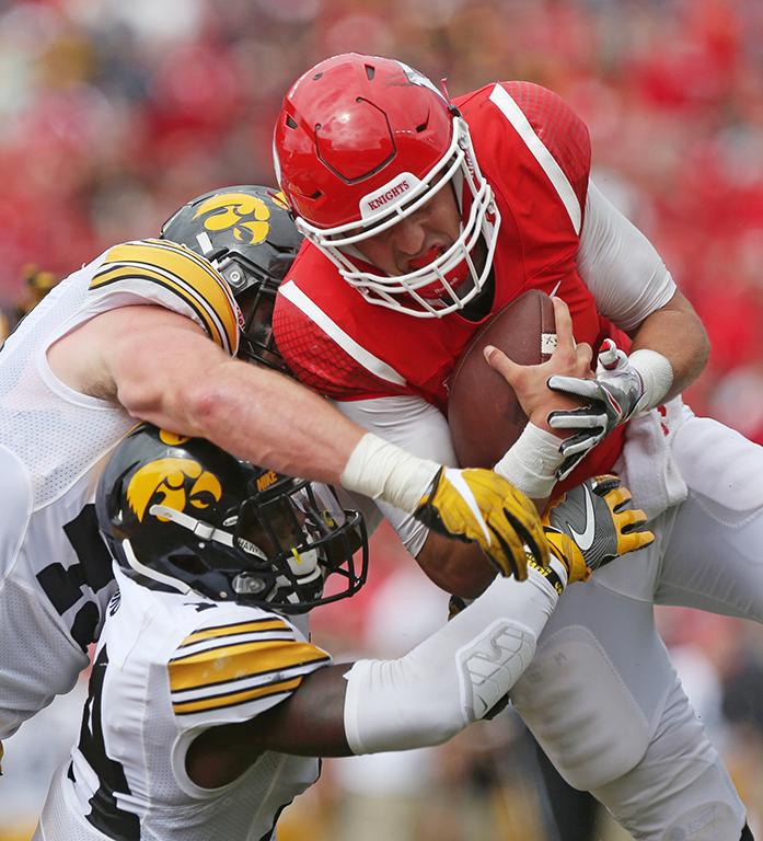 Rutgers quarterback Chris Laviano is brought down by Josey Jewell and Desmond King at the one yard line on the 4th down during the Iowa-Rutgers game at High Point Solution Stadium at Piscataway on Saturday, Sept. 24, 2016. The Hawkeyes defeated the Knights, 14-7. (The Daily Iowan/Margaret Kispert)