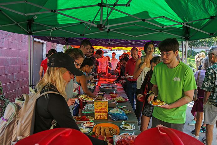 Students and members of the community help themselves to free samples at the Farmer's Market on Wednesday, Sept. 14, 2016. The annual Taste of the Market event gives the public a chance to try various items from vendors for free.  (The Daily Iowan/Anthony Vazquez)