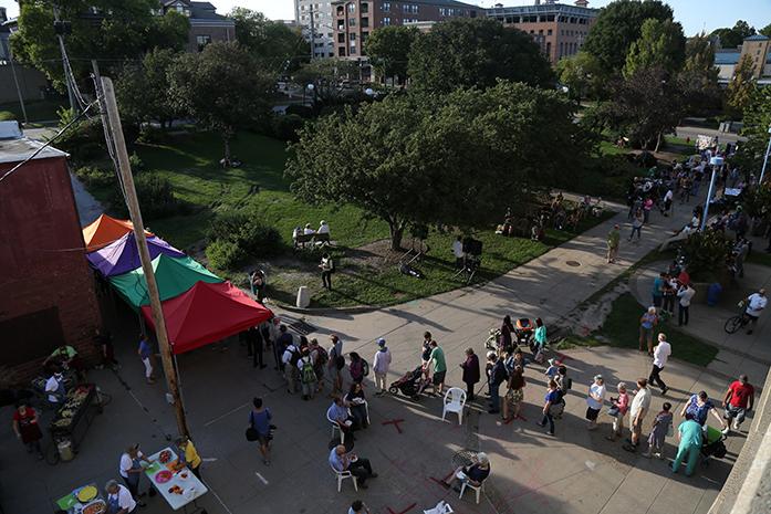 A line for the free samples stretches out at the Farmers Market on Wednesday, Sept. 14, 2016. The annual Taste of the Market event gives the public a chance to try various items from vendors for free. (The Daily Iowan/Anthony Vazquez)