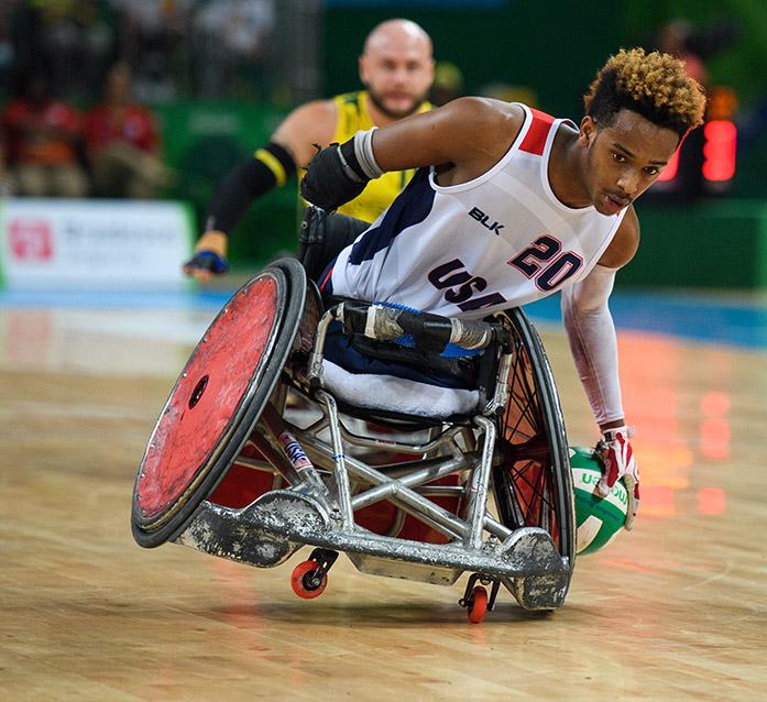 In this photo released by the IOC, Joshua Brewer of the USA moves towards the scoring zone during the gold medal match in the Mixed Wheelchair Rugby  match during the Paralympic Games, in Rio de Janeiro, Brazil , Sunday, Sept. 18, 2016. (Thomas Lovelock/OIS, IOC via AP)