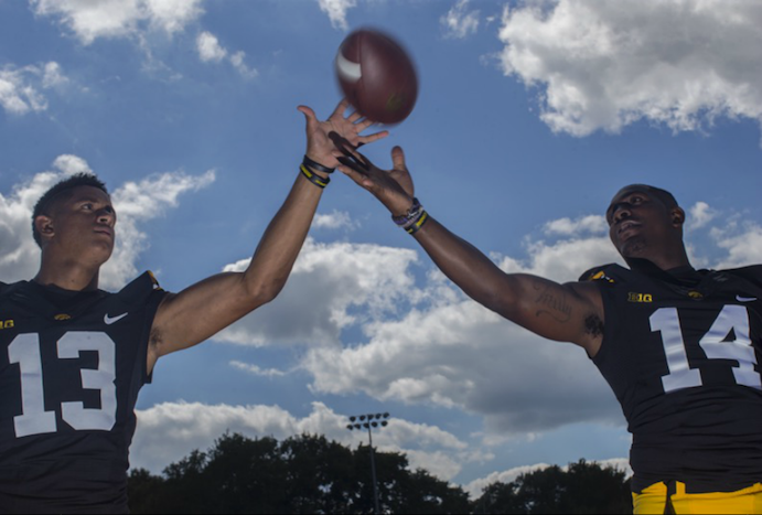 Iowa defensive backs Greg Mabin and Desmond King grab for a ball during Iowa’s football media day on Aug. 6. Iowa’s season -opener is against Miami (Ohio) on Saturday. (The Daily Iowan/Margaret Kispert)