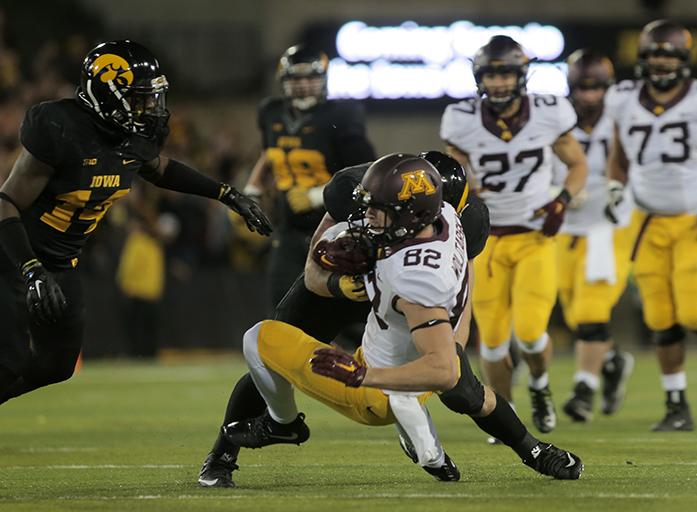 Minnesota wide receiver Drew Wolitarsky is tackled by Iowa lineman Josey Jewell during the Iowa-Minnesota game at Kinnick on Saturday, Nov. 14, 2013. The Hawkeyes defeated the Golden Gophers, 40-35 to stay perfect on the season. (The Daily Iowan/Margaret Kispert)