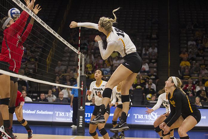 Iowa's no. 18 Lauren Brobst spikes the ball during a volleyball match at the Carver Hawkeye Arena in Iowa City on Friday, Sept. 16 , 2016. Iowa defeated Lamar 3-0. (The Daily Iowan/Ting Xuan Tan)