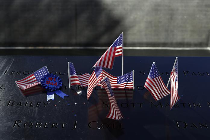 American+flags+and+a+ribbon+decorate+a+name+carved+into+the+north+pool+of+the+National+September+11+Memorial+on+the+15th+anniversary+of+the+attacks+of+the+World+Trade+Center%2C+Sunday%2C+Sept.+11%2C+2016+in+New+York+.+%28AP+Photo%2FMary+Altaffer%29
