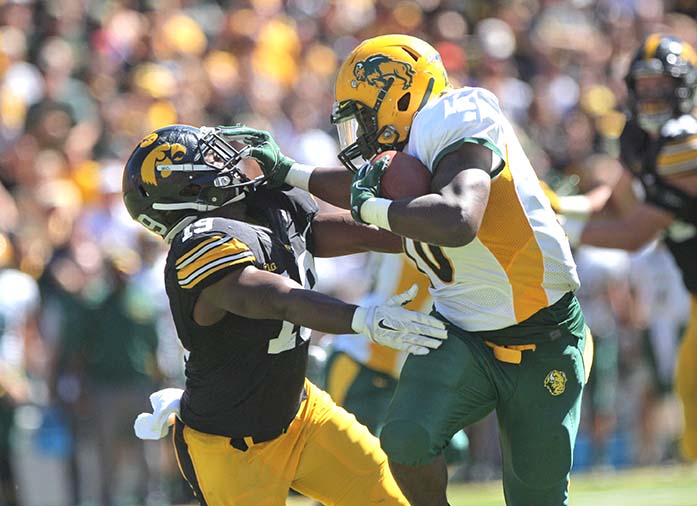 NDSU running back Lance Dunn stiff arms Iowa defensive back Miles Taylor during the Iowa-NDSU game at Kinnick on Saturday, Sept. 17, 2016. NDSU defeated Iowa in the final seconds of the game with a 37-yard field goal, 23-21. (The Daily Iowan/Margaret Kispert)