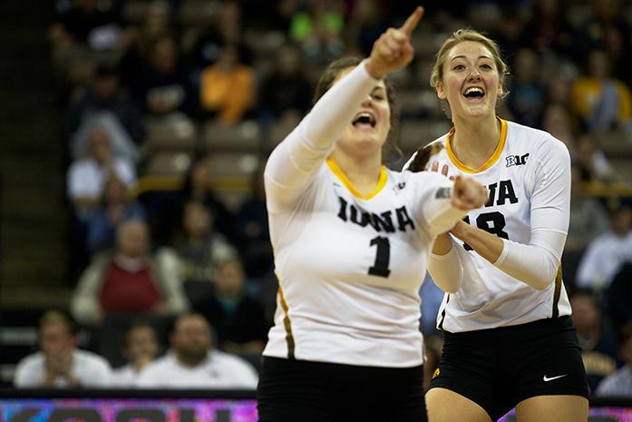 Iowa defensive specialist Molly Kelly and outside hitter Lauren Brobst celebrate a point at Carver-Hawkeye Arena on Wednesday, Nov. 11, 2015. Iowa fell to Penn State, 3-0. (The Daily Iowan/Rachael Westergard)