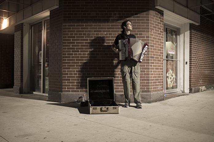 A+man+plays+the+accordion+on+the+street+corner+for+money+on+Friday%2C+September+30%2C+2016.+Friday+night+was+also+Homecoming+for+the+University+Hawkeye+football+team.+The+Hawkeyes+would+the+next+morning+go+on+to+lose+to+the+Northwestern+Wildcats.+%28The+Daily+Iowan%2FJordan+Gale%29