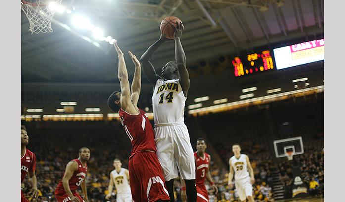 Iowa guard Peter Jok shoots the ball over Nebraska guard Tai Webster during the Iowa-Nebraska game in Carver-Hawkeye Arena on Tuesday, Jan. 5, 2016. The Hawkeyes defeated the Cornhuskers, 77-66. (The Daily Iowan/Margaret Kispert)